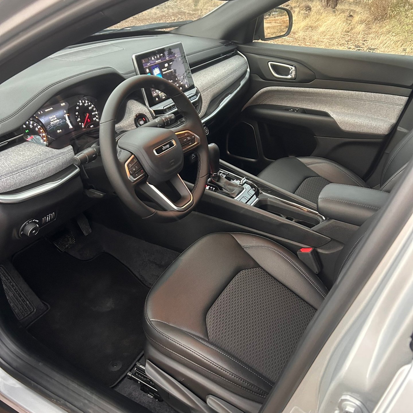 Car interior showing dashboard, steering wheel, and seats in a modern vehicle.